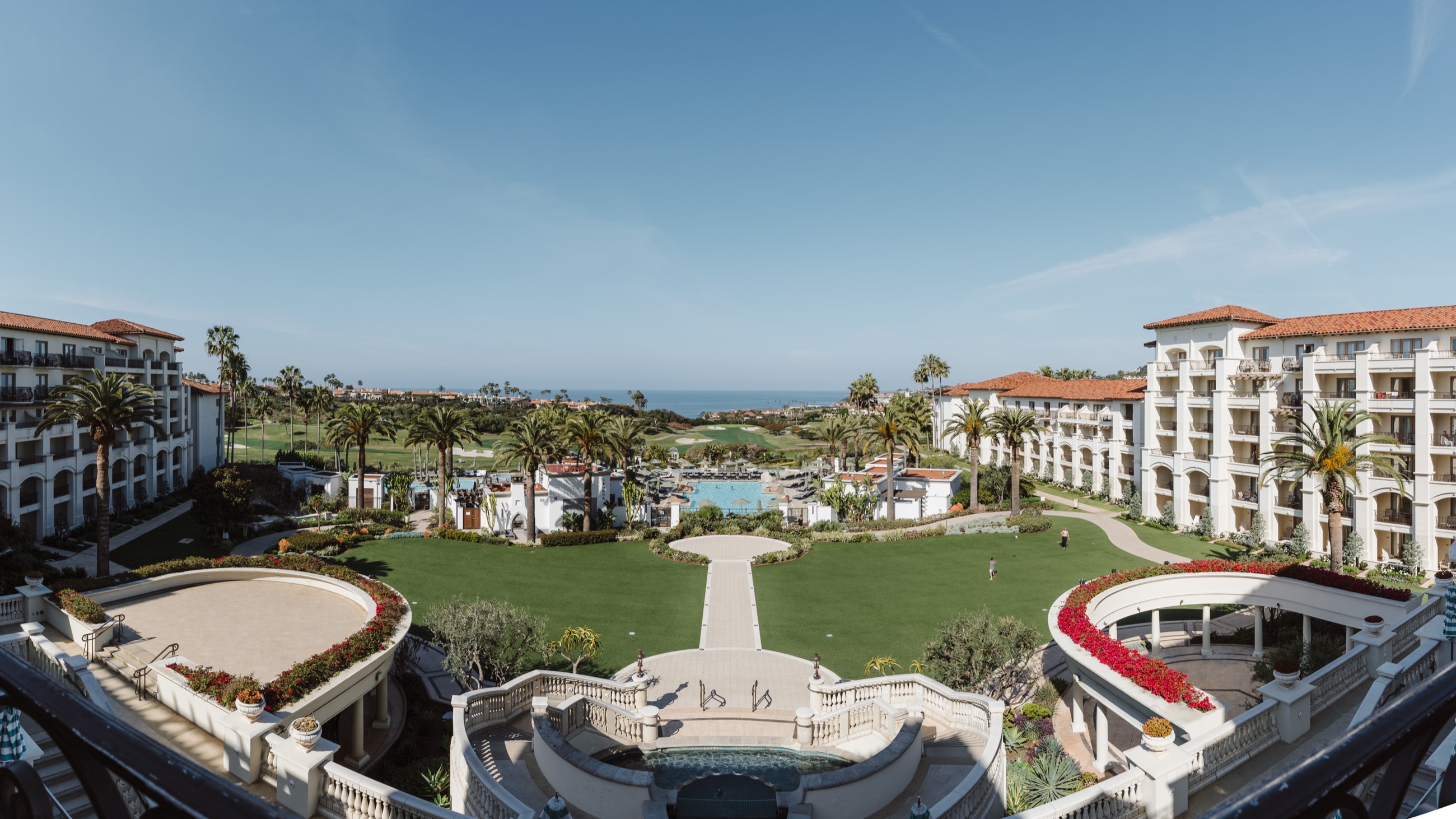 The Waldorf Astoria Monarch Beach resort seen from above, its lawn and pool running down to the Pacific
